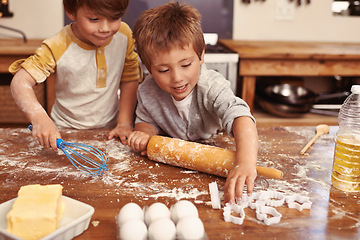 Image showing Children, baking and playing in kitchen with ingredients for dessert cake, cookies and fun. Cooking, mess and young brother siblings bonding together for happiness, utensils and smile in house.