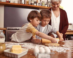 Image showing Grandma, smile and children baking in kitchen, learning or happy boys bonding together in family home. Grandmother, kids and cooking with flour, rolling pin or teaching brothers with dough at table