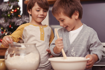 Image showing Boys, baking and happy in kitchen with flour, home and learning with ingredients for christmas cake. Children, mixing or bowl for cookies on counter, biscuits or pastry recipe for holiday celebration