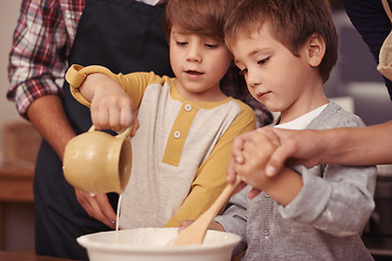 Image showing Children, learning or baking in kitchen with ingredients, home or support for dessert cake with love. Happy family, teaching or bowl for cookies on table, care or bonding together on holiday in house