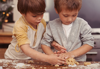 Image showing Boys, cutter and baking in kitchen with dough, home and learning to bake a christmas cake. Children, playing and shape for cookies on counter, biscuits and wheat pastry for sweet dessert on holiday