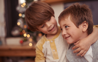 Image showing Happy children, hug and together for christmas in home, bonding and playing with love on holiday. Boys, siblings and excited with social or talking, care and embrace for family on vacation in house