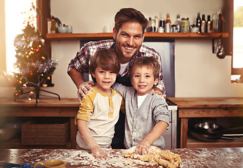 Image showing Father, portrait and happy children baking at Christmas, learning or bonding together in home. Face, kids and dad cooking at xmas on holiday with flour for teaching brothers with family in kitchen