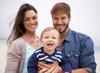 Image showing Mother, father and portrait with toddler at beach for family, love and adventure together on vacation. Happy, man and woman with baby by ocean for support, travel and relaxing holiday in Los Angeles