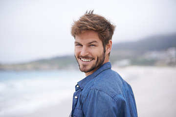 Image showing Happy, portrait and beach with man on summer vacation, getaway trip and adventure. Ocean, smile and male person for happiness, wellness and travel destination for peace, weekend break and tourism.
