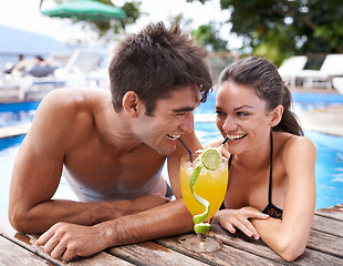 Image showing Swimming pool, cocktail and couple with holiday, sunshine and weekend break with happiness, relax and honeymoon. Summer, man or woman with tropical drink or wet with getaway trip or luxury with water