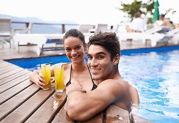 Image showing Swimming pool, cocktails and couple with holiday, portrait and weekend break with vacation and honeymoon. Sunshine, man or woman with tropical drink and wet with luxury or summer with love or alcohol