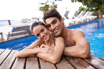 Image showing Couple, portrait in pool and hug outdoor, love and connection with summer vacation at resort or hotel. Happy people, swimming or relax in jacuzzi for romantic date or getaway with trust and bonding