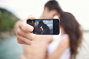 Image showing Couple, phone screen and selfie on beach, travel and love on honeymoon vacation. Happy man, woman and cellphone picture for holiday memories, social media and adventure overseas to seaside Bali