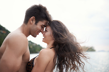 Image showing Couple, forehead touch and travel to ocean on vacation, love and relax by water on holiday. People, swimwear and bonding for relationship in outdoors, support and smile on trip to sea or nature