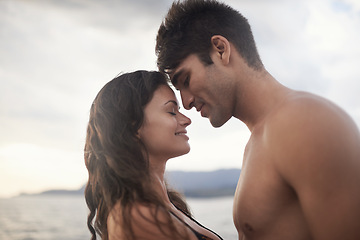 Image showing Love, happy couple and touch face at ocean for vacation, holiday or travel together in summer. Man, woman and intimate at sea for connection, care or bonding on adventure by water outdoor in nature