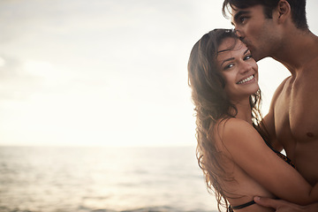 Image showing Portrait, happy couple and kiss at sea at sunset on vacation, holiday or travel together. Face, man and woman at ocean for adventure, romance or connection in summer by water for love on mockup space