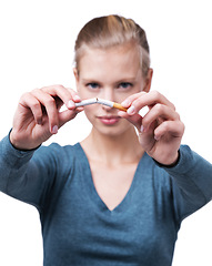 Image showing Studio, portrait and woman with broken cigarette to quit tobacco for health, wellness and results. White background, girl and stop smoking for healthcare benefits, commitment and addiction support.