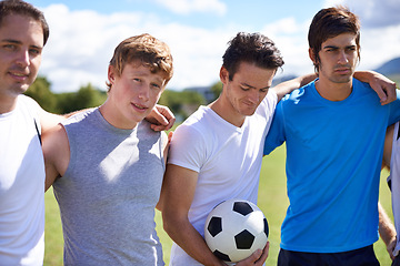 Image showing Soccer, men and hug together on field for portrait at game with fitness, exercise and wellness in nature. People, teamwork and embrace for support, solidarity and football with friends in competition