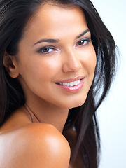 Image showing Woman, portrait and smile in studio for cosmetics with glowing skin, makeup and collagen facial treatment. Model, person and face with confidence for skincare, beauty and wellness on white background