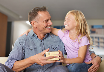 Image showing Hug, father and child with present in home on birthday or giving a box for special event. Family, gift and offer dad package and embrace to show gratitude, love or kid with kindness in living room