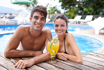 Image showing Swimming pool, cocktail and couple with portrait, summer and weekend break with vacation and honeymoon. Sunshine, man and woman with tropical drink and love with holiday and luxury with celebration