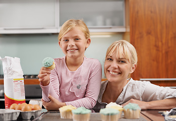 Image showing Happy, mom and child with cupcake in kitchen and learning about baking together in home to relax. Family, bonding and kid smile with mother, excited for eating cake, sweets or enjoy food in house