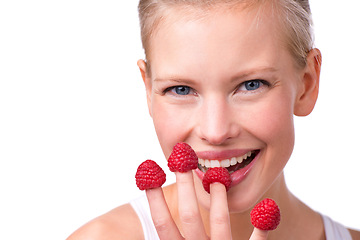 Image showing Portrait, health and raspberries on fingers of woman in studio isolated on white background for diet. Face, smile and fruit with happy young person eating for weight loss, detox or nutrition