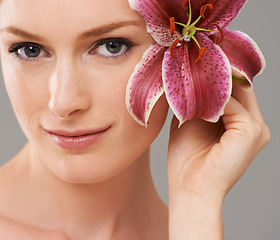 Image showing Beauty, flower and woman in studio with natural, organic and skincare face routine for wellness. Cosmetic, mockup and person with floral plant for facial dermatology treatment by white background.