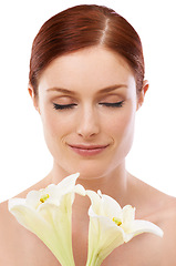 Image showing Scent, skincare and woman with flower, lily and natural beauty isolated on white studio background. Makeup, smell and model with floral cosmetics, eyes closed and glow for wellness with organic plant