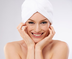 Image showing Studio, happy woman and portrait with hair in towel and skincare in spa facial with cosmetology. Young model, smile and face for dermatology with clean shower and body treatment by white background