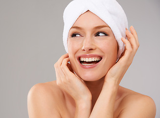 Image showing Happy, woman and thinking about skincare for beauty and healthy dermatology in studio background. Girl, smile and model laughing with glow on skin from facial, cosmetics or towel for self care