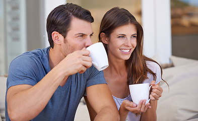 Image showing Couple, morning and lounge with coffee in home for smile, thinking and relax on sofa with drink. Man, woman and happy together with latter, coco or tea cup with bonding, love and ideas on vacation