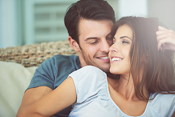 Image showing Happy, love and couple relaxing on sofa for bonding in living room at apartment together. Smile, resting and young man and woman laying on couch for romance and marriage in lounge at modern home.