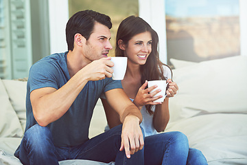 Image showing Couple, morning and coffee on sofa in home for smile, thinking or relax with drink. Man, woman and happy for conversation with latte, coco or tea cup for bonding, love and idea on vacation with couch