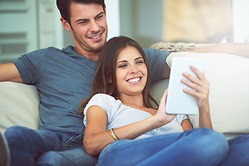 Image showing Happy couple, relax and sofa with tablet for social media, entertainment or movie together at home. Man and woman laughing with smile on technology for online streaming, series or show in living room