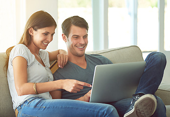 Image showing Happy couple, pointing and laptop with credit card for ecommerce, payment or purchase on sofa at home. Man and woman with smile or debit on computer for choice or order in online shopping or banking