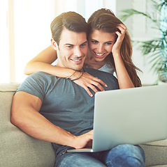 Image showing Laptop, smile and woman hugging husband on sofa networking on social media, website or internet. Happy, love and female person embracing man reading online blog with computer in living room at home.