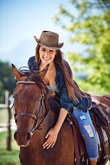 Image showing Portrait of woman, smile or horse riding on countryside farm as equestrian for training, sport or cowboy hat. Happy female person, saddle or western farming in Texas or environment, outdoor or stable