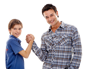 Image showing Dad, portrait and arm wrestle with child for game of strength, power or playful bonding on a white studio background. Father, son or kid with handshake in battle for challenge, parenting or childhood