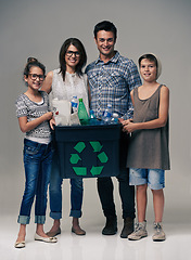 Image showing Parents, kids and studio portrait with recycling for sustainability, ecology and background. Mother, father and children in family with container, plastic and bottle for cleaning environment