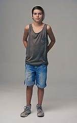 Image showing Young boy, portrait and fashion with denim shorts or jeans for style on a gray studio background. Male person, child or teenager with summer clothing or cool stylish outfit with beanie on mockup