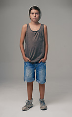 Image showing Young boy, portrait and fashion with style in denim shorts or jeans on a gray studio background. Male person, child or teenager with summer clothing or cool stylish outfit with a beanie on mockup