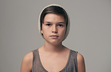 Image showing Boy, beanie and fashion in studio for portrait with teenager, edgy and aesthetic by background. Kid, model and hat with trendy style, face and pride for clothes with confidence for punk outfit