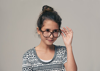 Image showing Kids, vision and glasses with happy girl child in studio isolated on gray background for optometry. Children, frame and eyewear with young female kid at eye clinic for prescription eyesight test