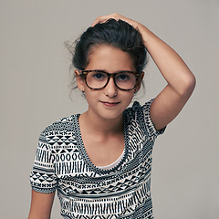 Image showing Portrait, fashion and glasses with girl child in studio isolated on gray background for optometry style. Kids, frame lens or eyewear with cute young geek or nerd in clothes outfit and accessories