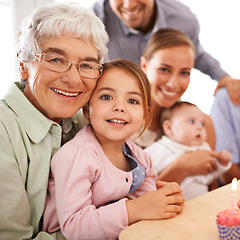 Image showing Family, grandmother or young child for birthday, cupcake and candle for celebration. Smile, home and grand daughter with grandma, senior and children at event, parents and baby in household party