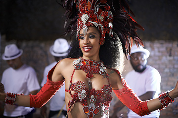 Image showing Artist, dancer and performance of samba by woman in Rio de Janeiro, happiness and celebration with energy. Female person, culture and clothes from feather for fashion in carnival, music and Brazil