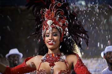 Image showing Samba, woman and dancing with band at carnival in rio de janeiro for brazilian festival with feather costume or happy. Dancer, face or night with energy, fashion or music for culture or outdoor event