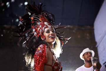 Image showing Night, woman or dancer with samba at carnival in rio de janeiro for brazilian festival with feather costume or smile. Person, face or party with dancing, fashion or music for culture or outdoor event