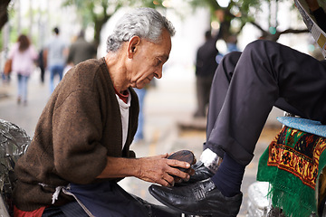 Image showing Shoe cleaner, elderly man person and shining feet, small business owner and professional on busy street. Mature, senior male and experienced worker from Puerto Rico, working with brush in city