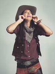 Image showing Crying, cowgirl and unhappy with sad expression in studio with stress, tears and upset with sorrow. Female person, costume and hat for western fashion, isolated and emotional with grey background