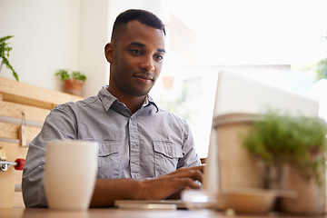 Image showing Black man, typing and laptop for remote work from cafe, restaurant and coffee shop in creative career. African male person, writer or freelancer for media website, social networks or blogging