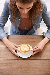 Image showing Woman, top view and coffee at a cafe, restaurant and diner with tea cup, latte and espresso for drinking, break and relaxation. Female adult, hot beverage and table at canteen, bistro or cafeteria