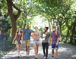 Image showing Students, friends and walking on campus with learning, knowledge and books or talking of college. Group of people with outdoor conversation in a park or university for education, study or opportunity